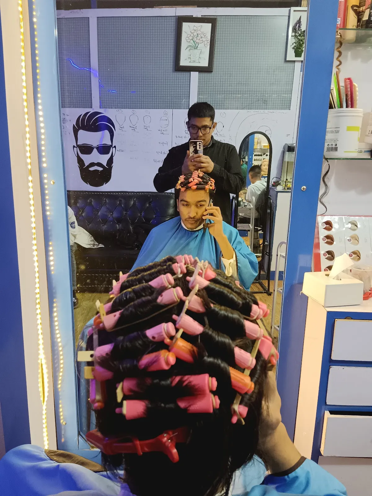 Pink rollers set during a perm service